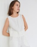 Model wearing white linen crop top