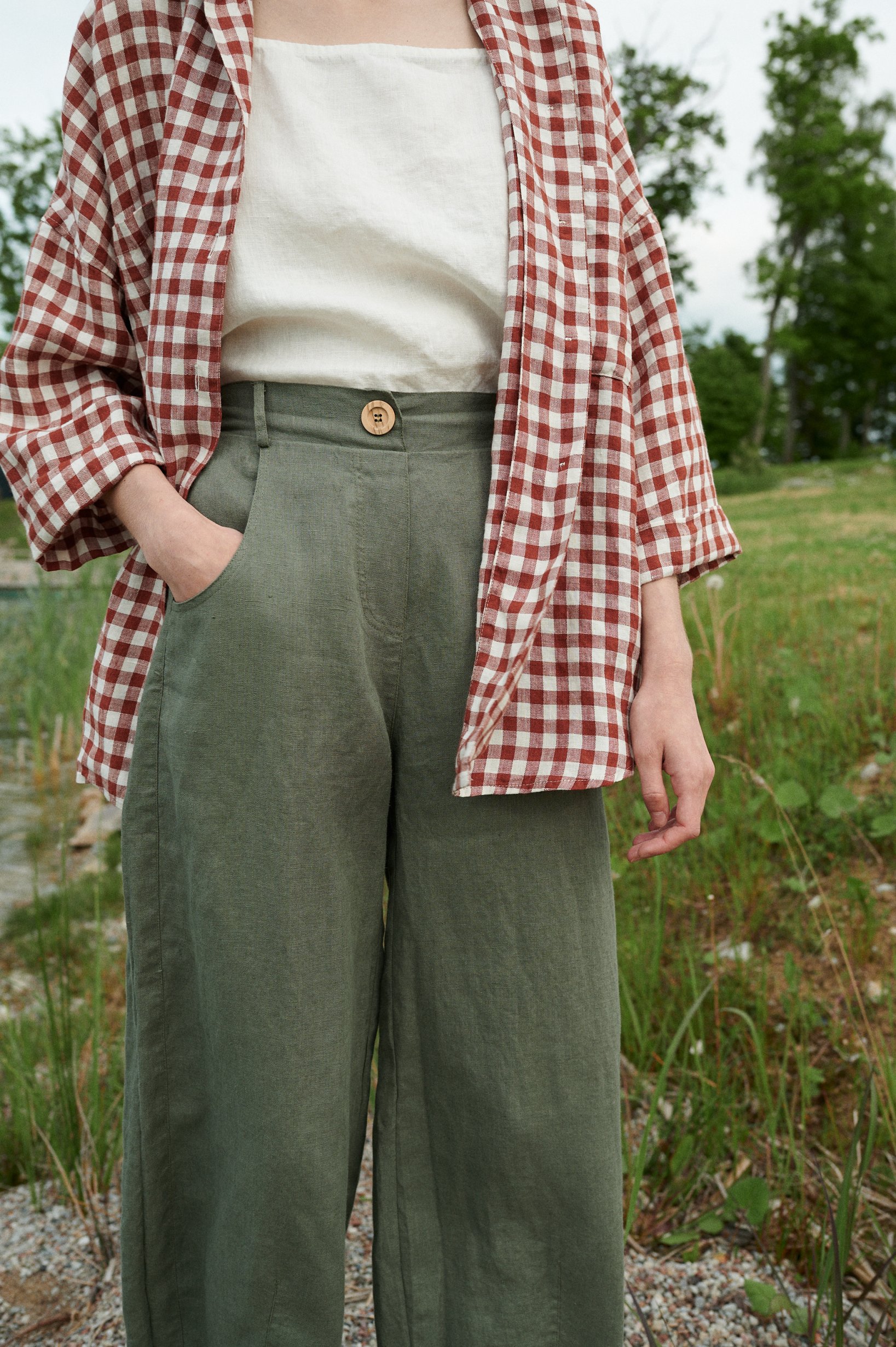 Pine green linen trousers on a model