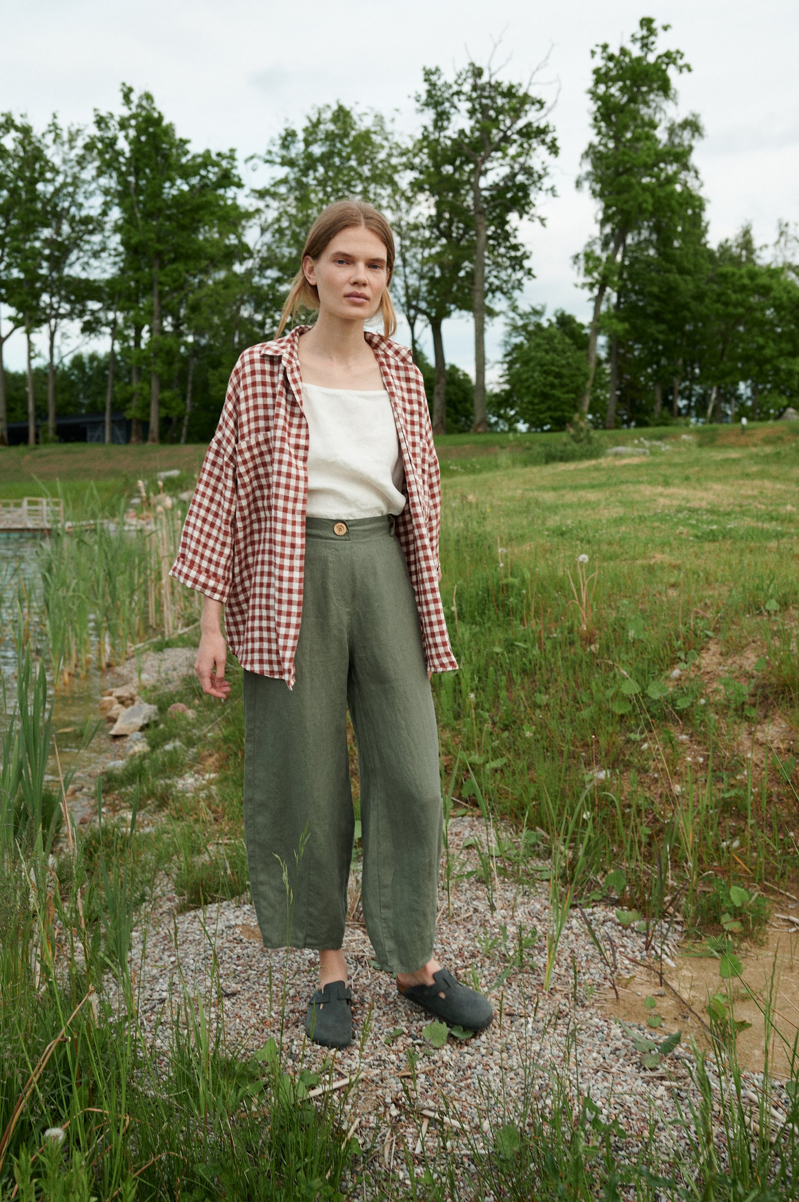 A model wearing green natural linen wide leg trousers
