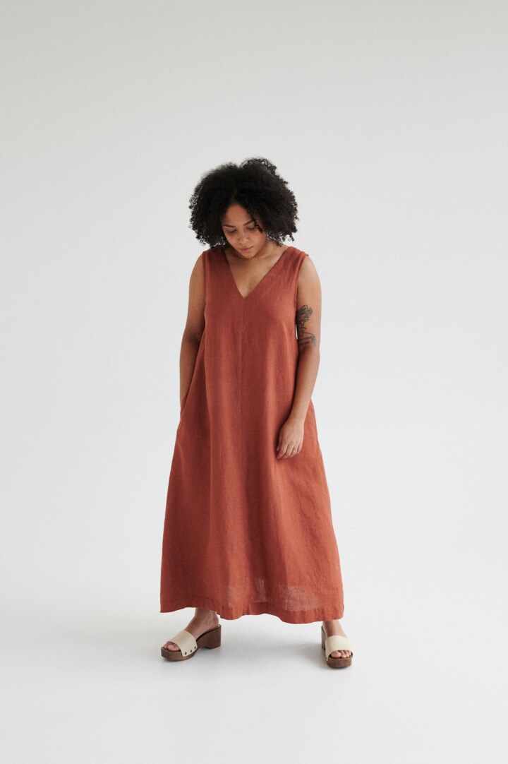 Terracotta linen dress with deep V-neckline and A-line silhouette