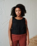 A casual sleeveless linen top with a round neckline