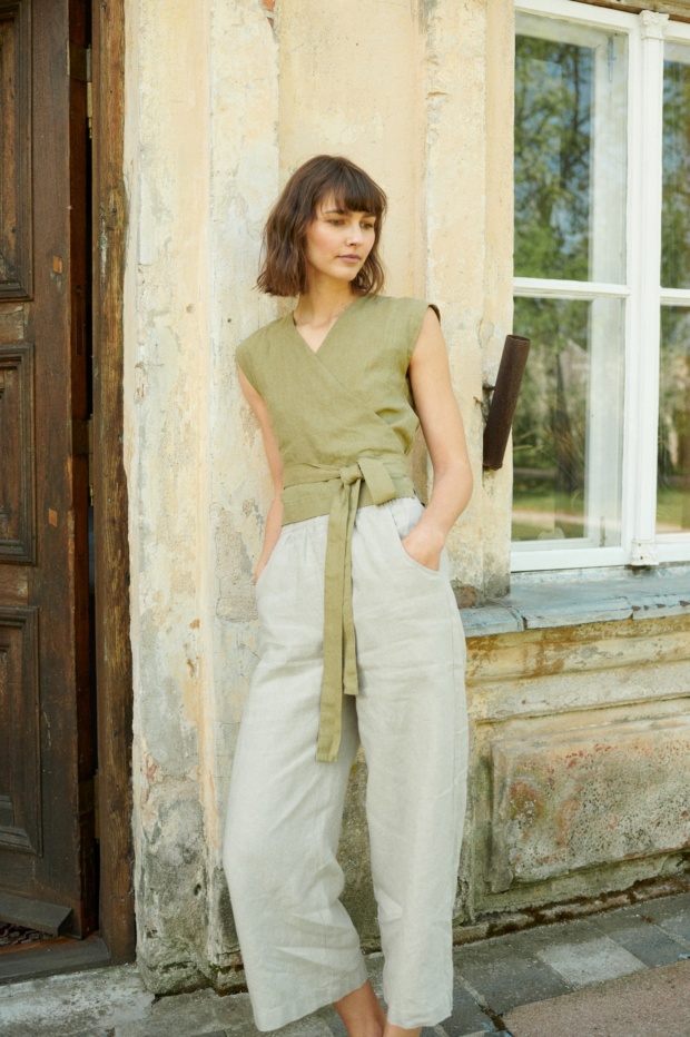 A model wearing wide leg natural linen trousers