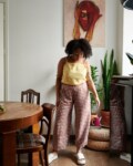 A model in brown gingham linen trousers