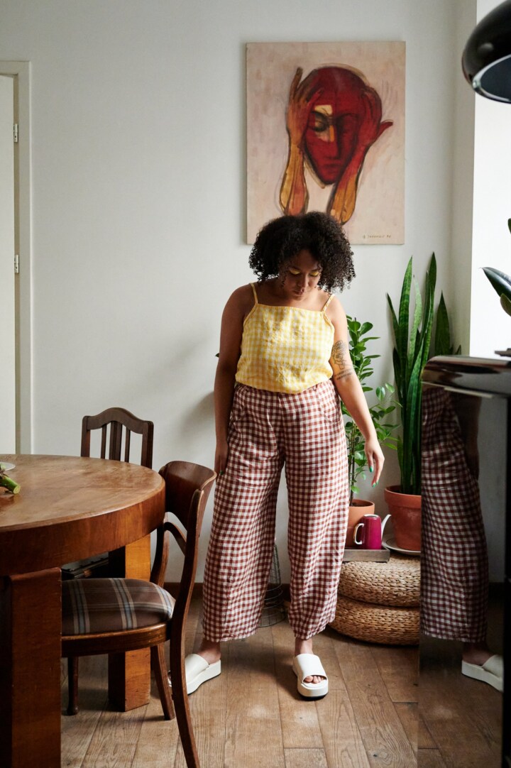 A model in brown gingham linen trousers