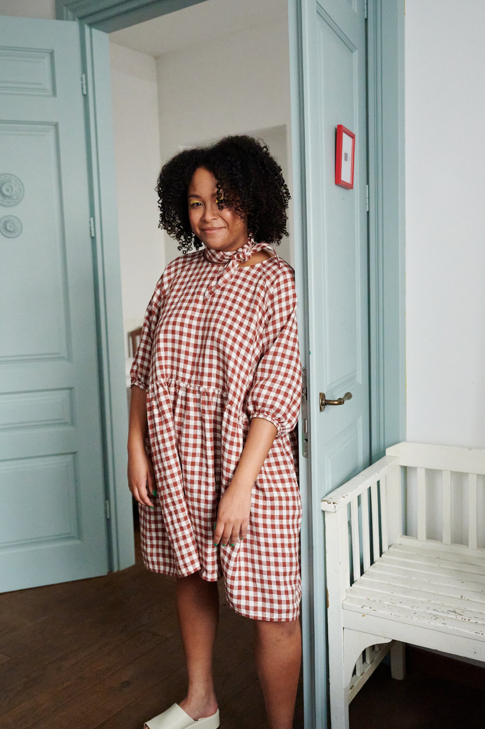 Woman wearing terracotta gingham linen dress