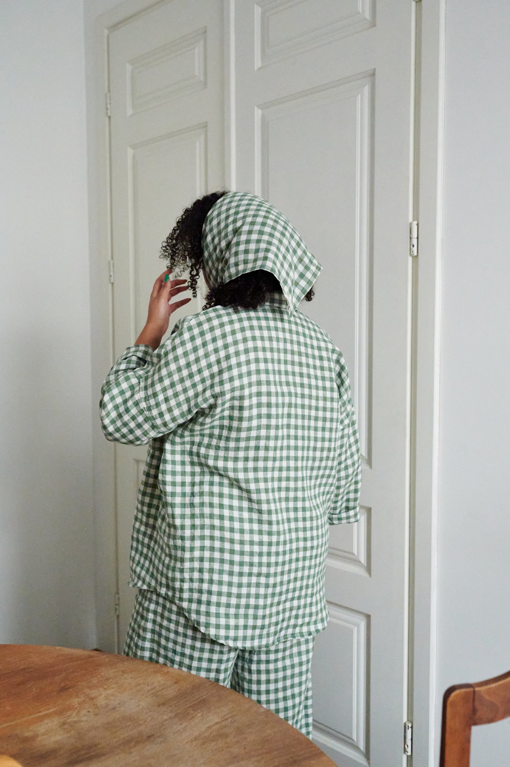 Model in relaxed-fit green gingham linen outfit