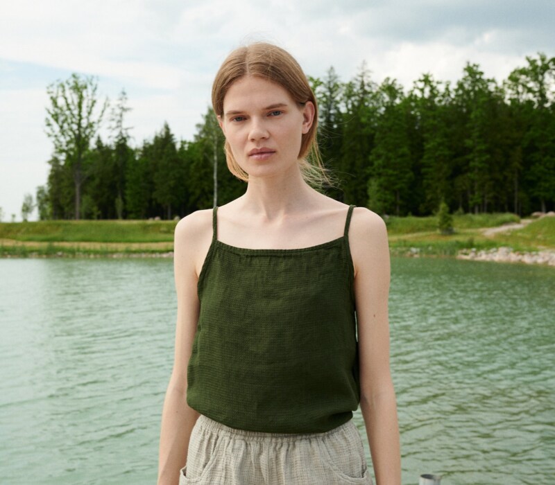 A dark green waffle linen summer top with thin straps and a high neckline