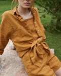 An oversized waffle-like textured linen button down shirt tied in the front