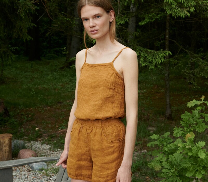 A waffle linen top with thin straps tucked into linen shorts