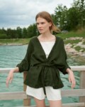 Woman wearing an oversized waffle linen jacket paired with a white linen summer top and shorts