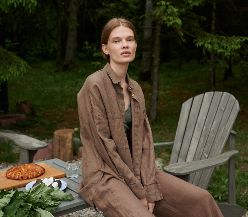 Model in a loose-fitting waffle linen button down shirt and matching linen trousers outfit