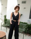 A woman wearing heavy linen black trousers