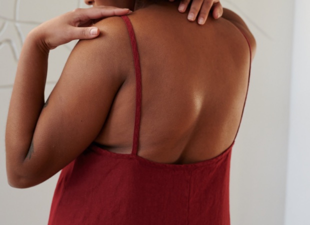 Back details of a red linen dress showing spaghetti straps and a low-cut back
