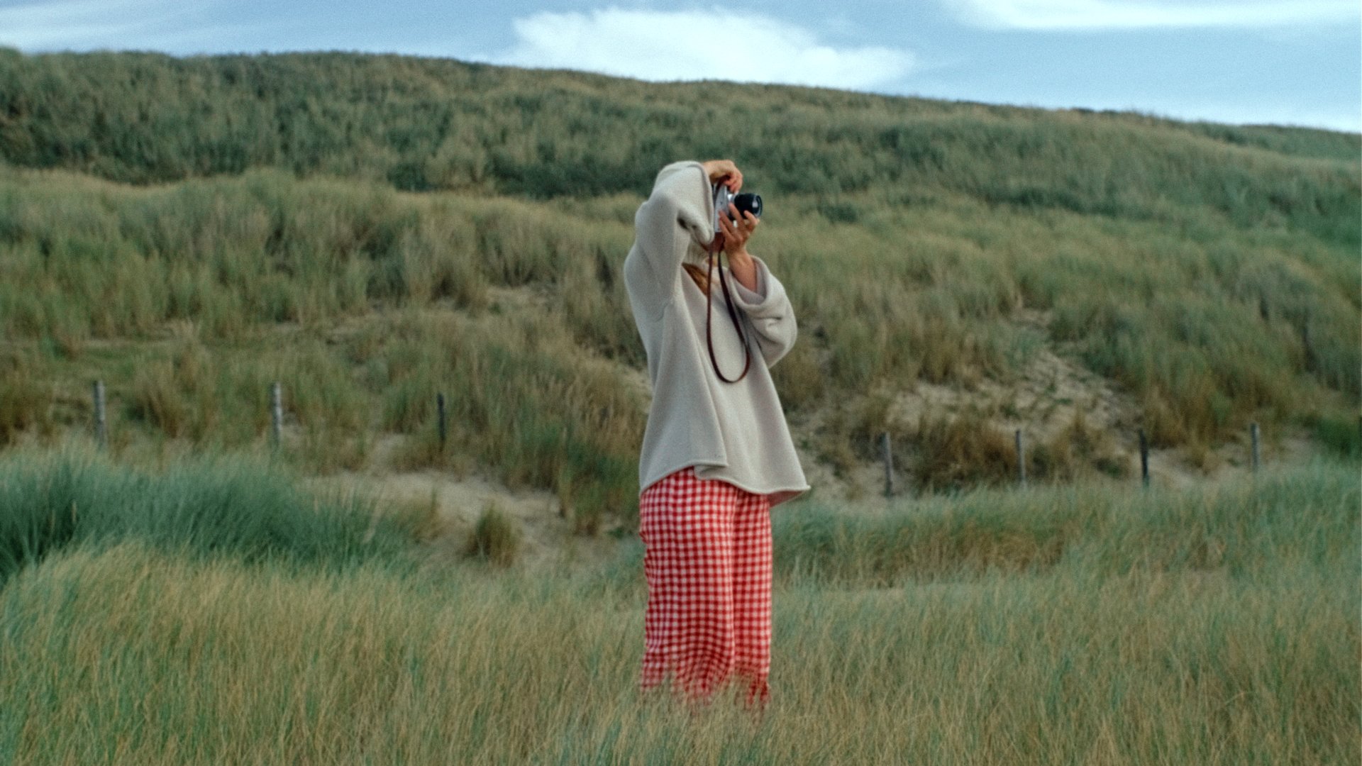 woman wearing linen trousers red gingham by the sea