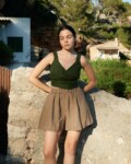 women is wearing brown linen shorts in hot weather