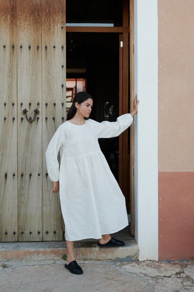 Woman twirling in a flowy Margo linen dress in the city