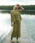 women is wearing button up maxi skirt in heavy olive linen