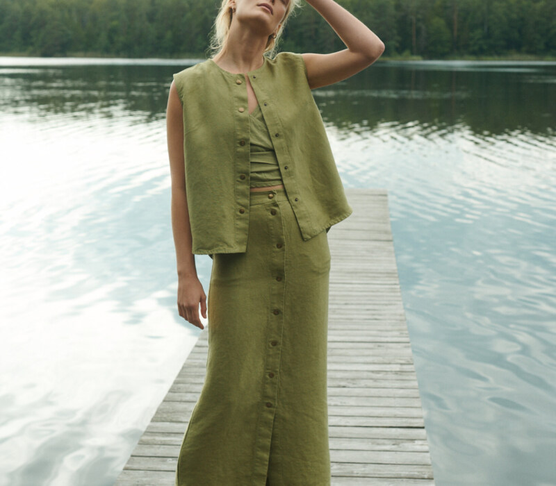 women is wearing button up maxi skirt in heavy olive linen