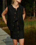 women is wearing black button up skirt made from heavy linen fabric
