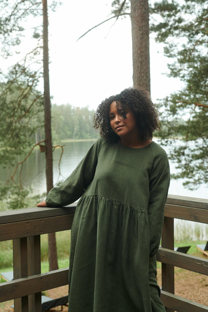 model is wearing a green wool dress in full length