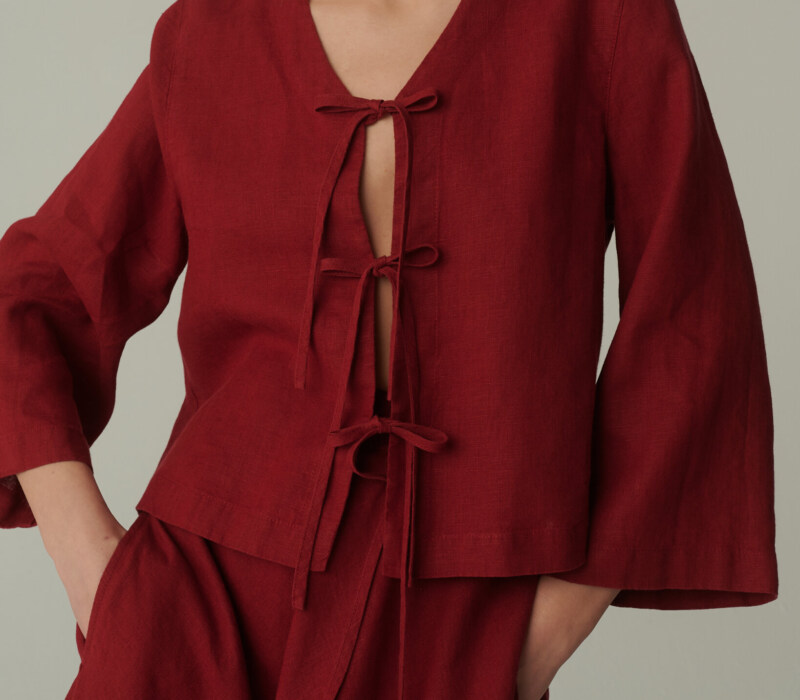 model is wearing red tie front top