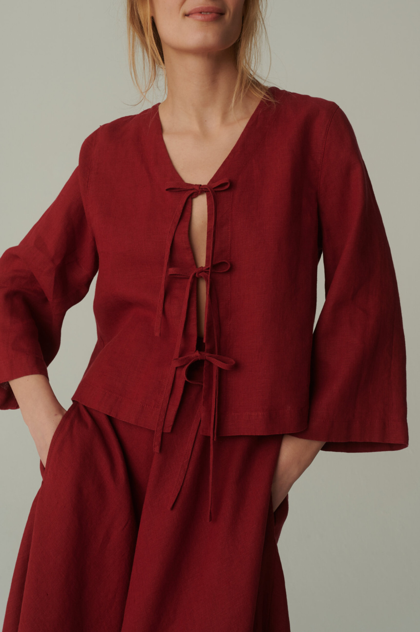 model is wearing red tie front top