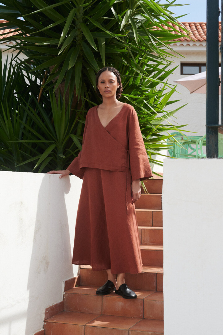 women is wearing summer linen skirt in terracotta color