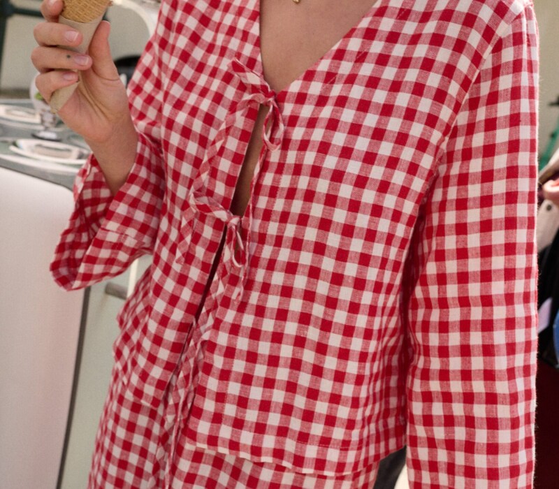 model is wearing red gingham top