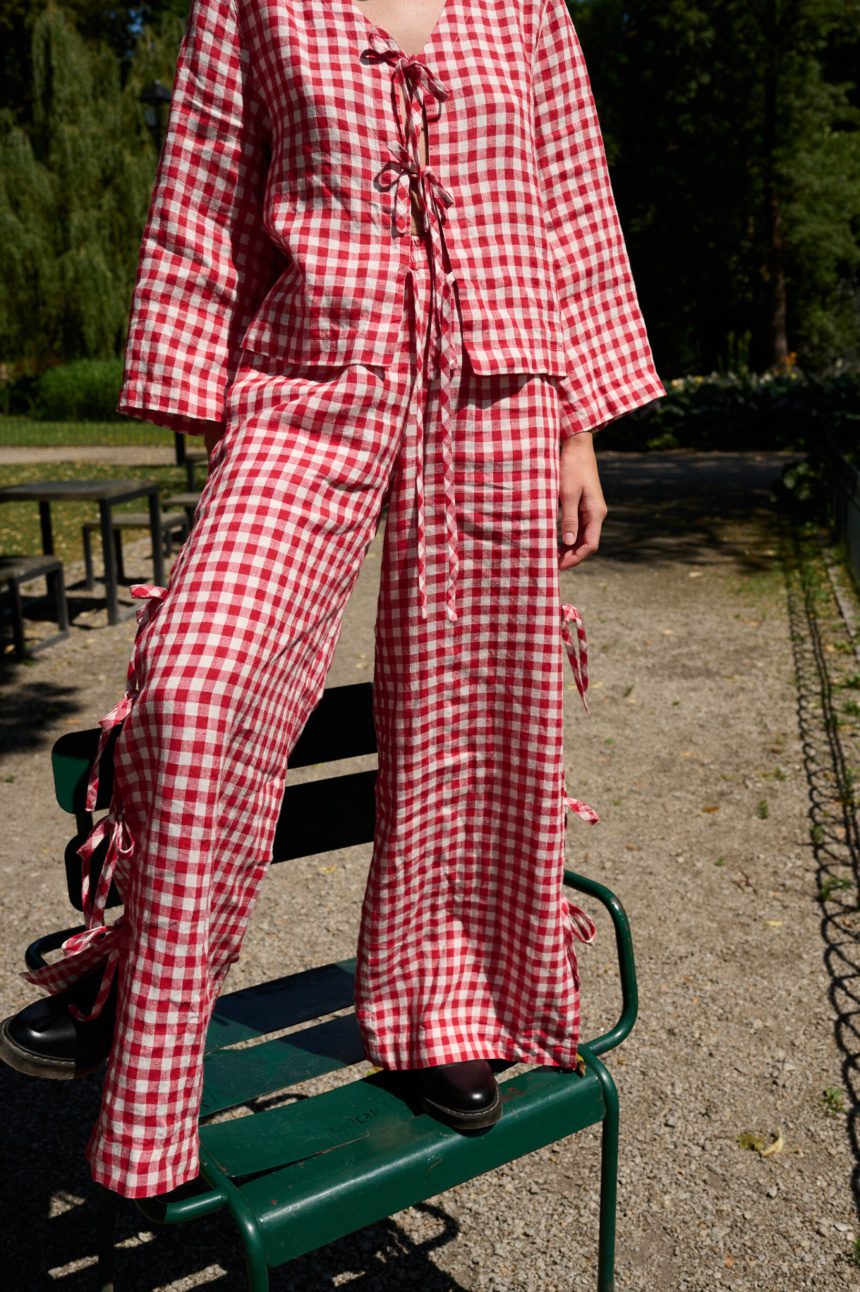Red gingham wide leg pants with side ties and adjustable slit detail