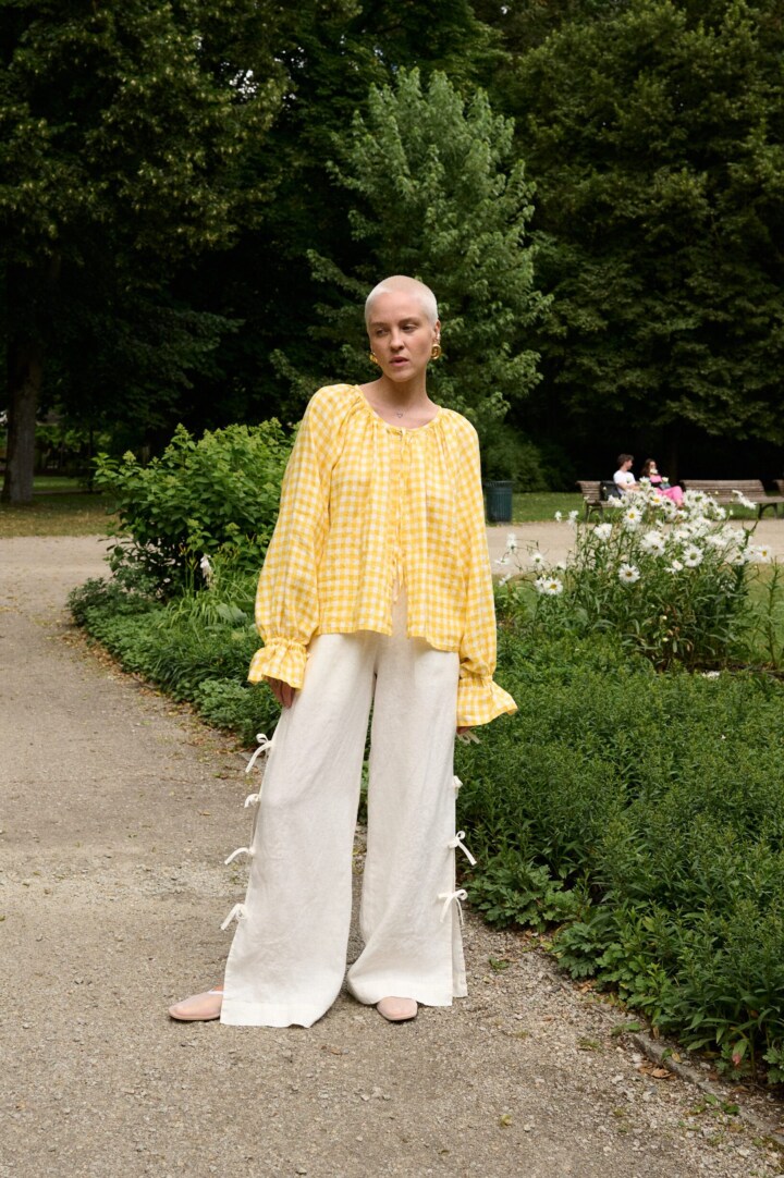 model is wearing gingham blouse in yellow