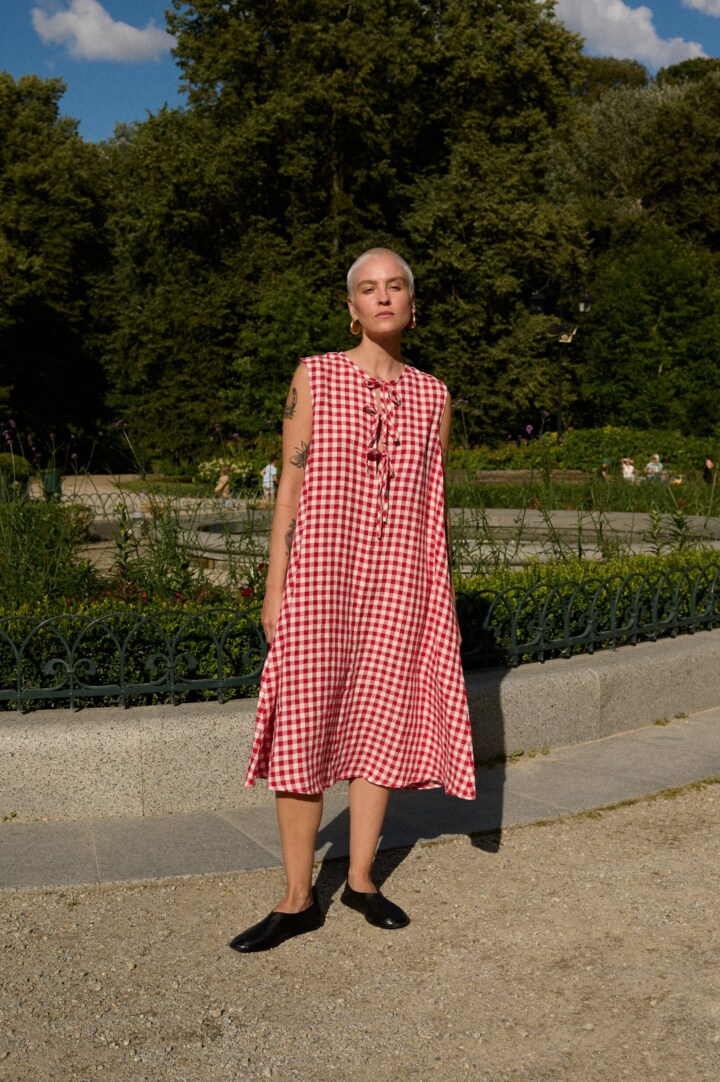 women is wearing red and white gingham dress in linen