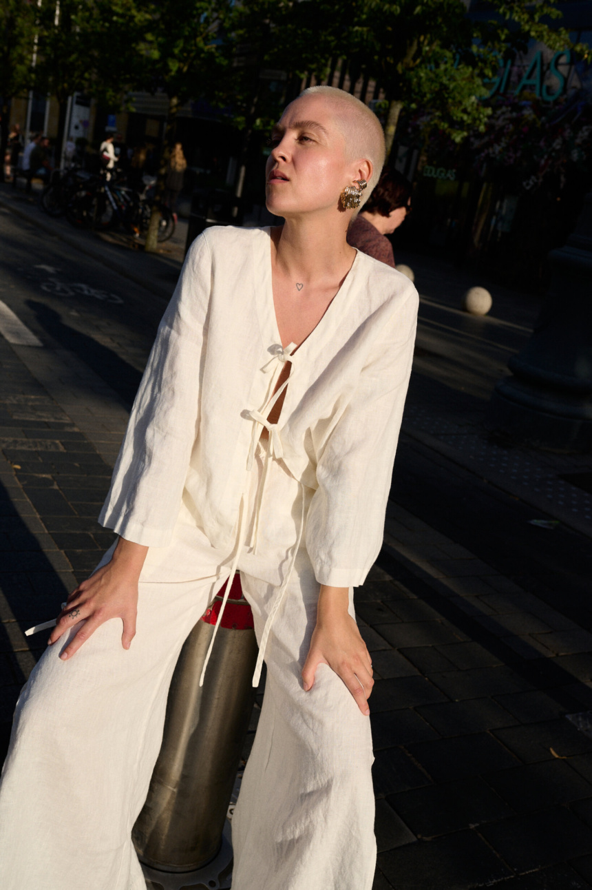 model is wearing white tie front top in linen fabric
