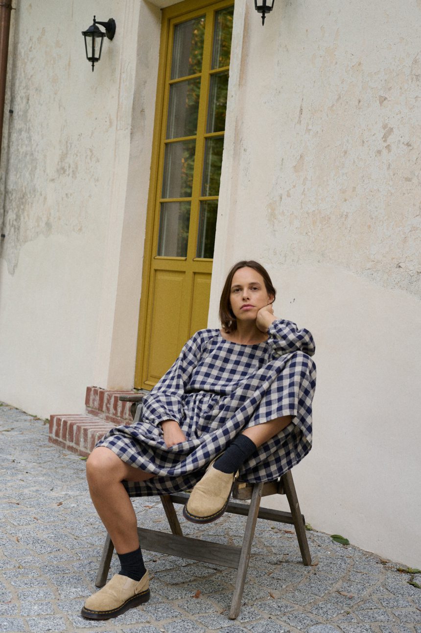 model wearing navy blue gingham linen dress