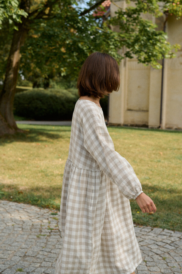 model wearing grey gingham linen dress