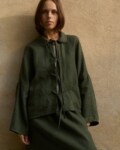 Model is wearing green wool jacket
