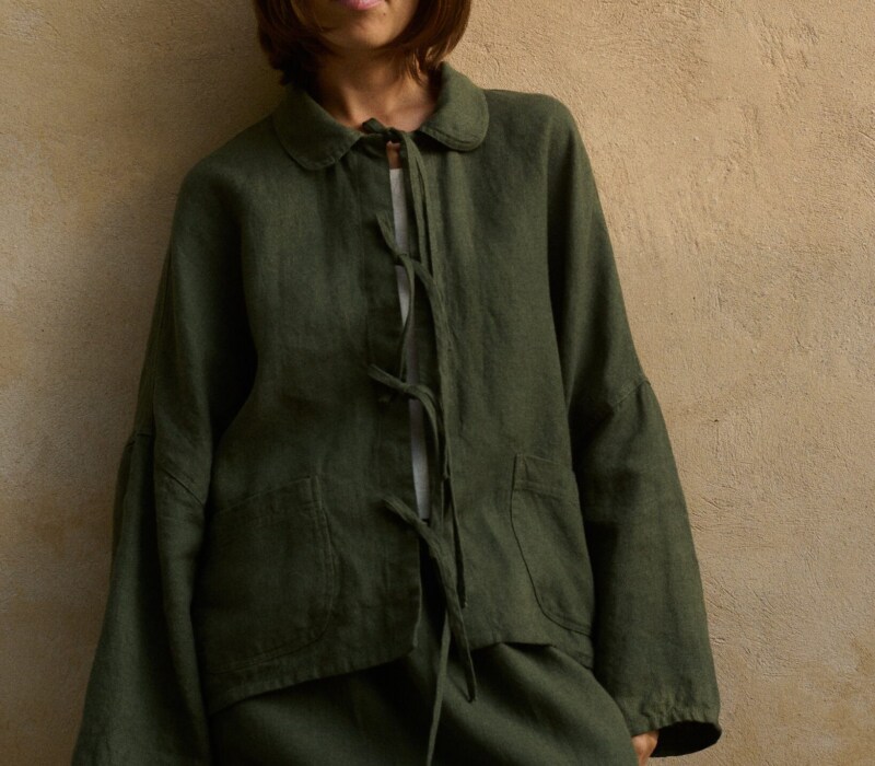 Model is wearing green wool jacket
