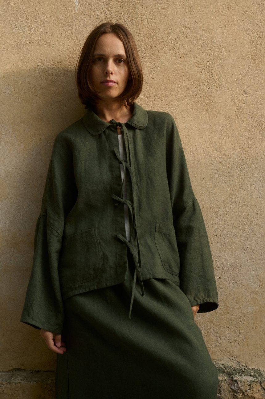 Model is wearing green wool jacket