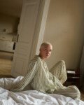 woman wearing green striped linen pajama set