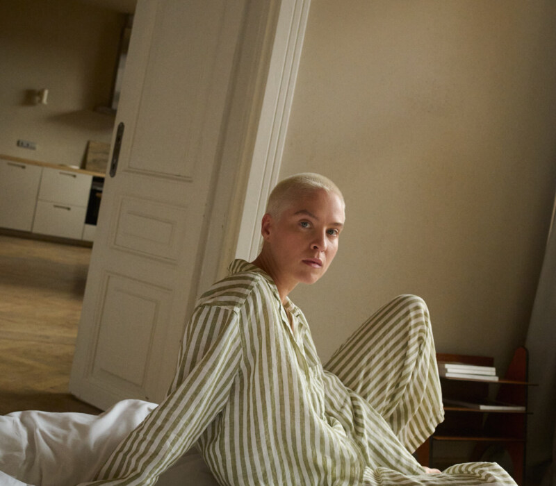 woman wearing green striped linen pajama set