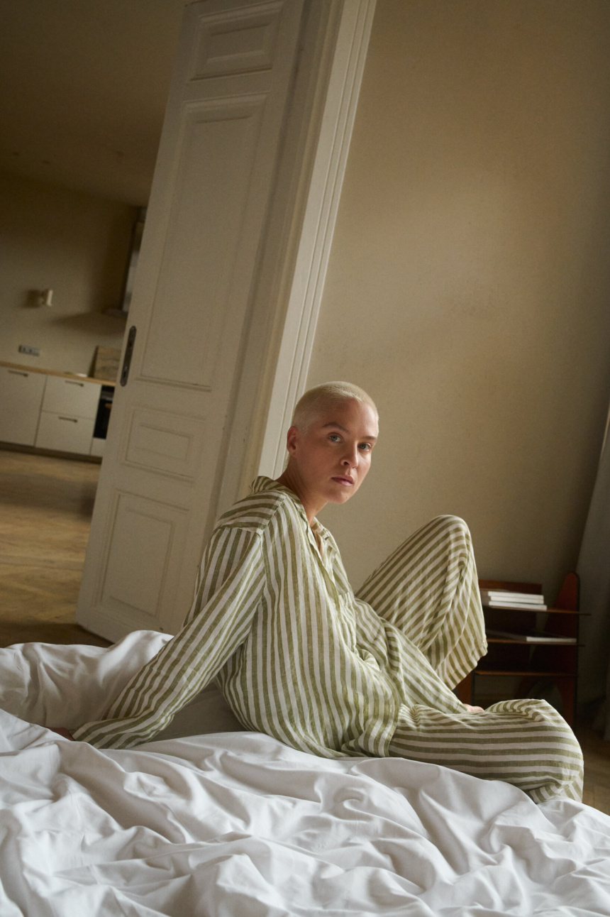 woman wearing green striped linen pajama set