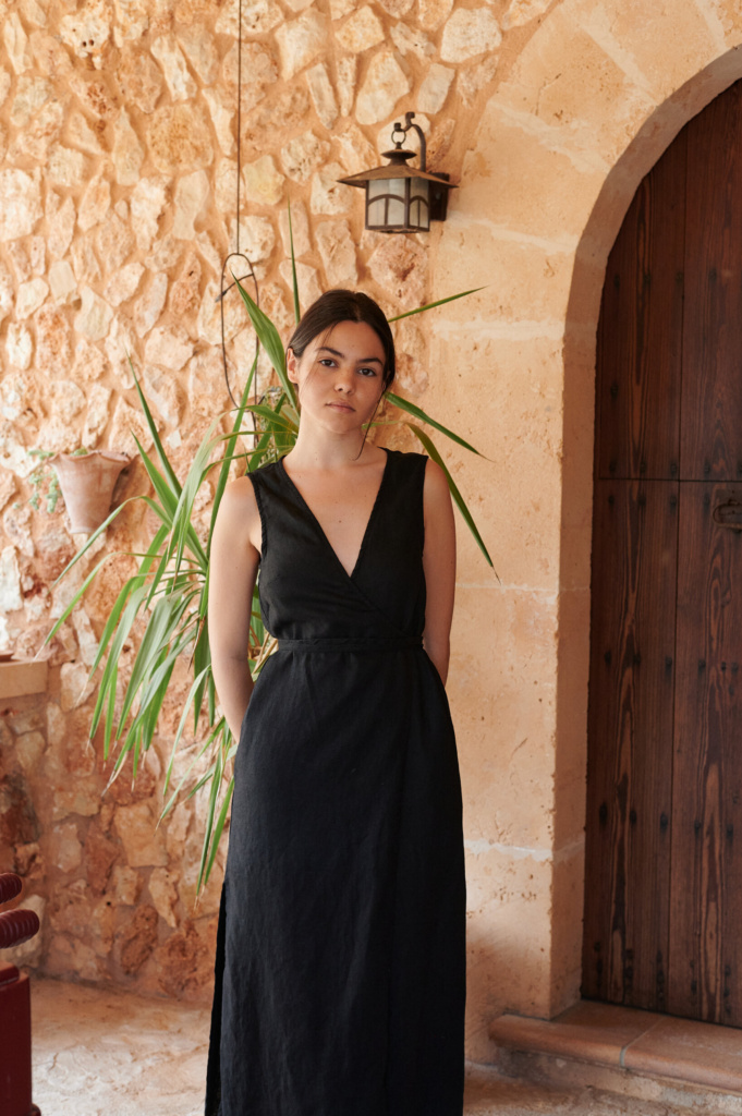 Women wearing long wrap linen dress in black.