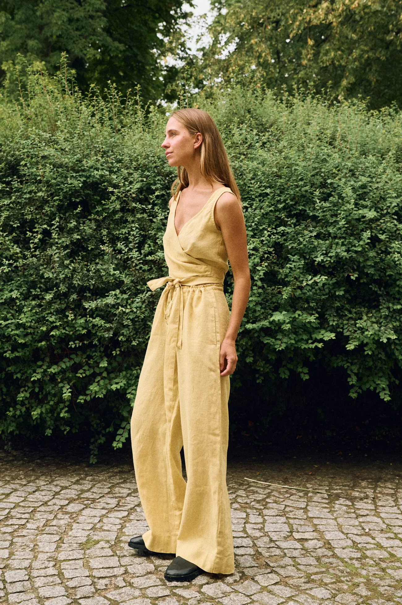 Butter yellow linen wrap top and wide leg trousers worn together as a relaxed summer outfit