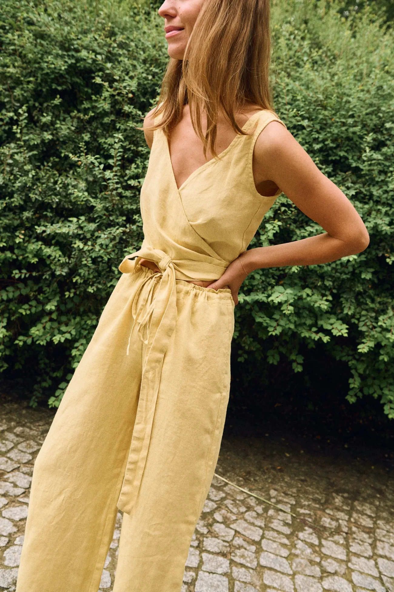 Butter yellow linen sleeveless wrap top styled with wide leg trousers