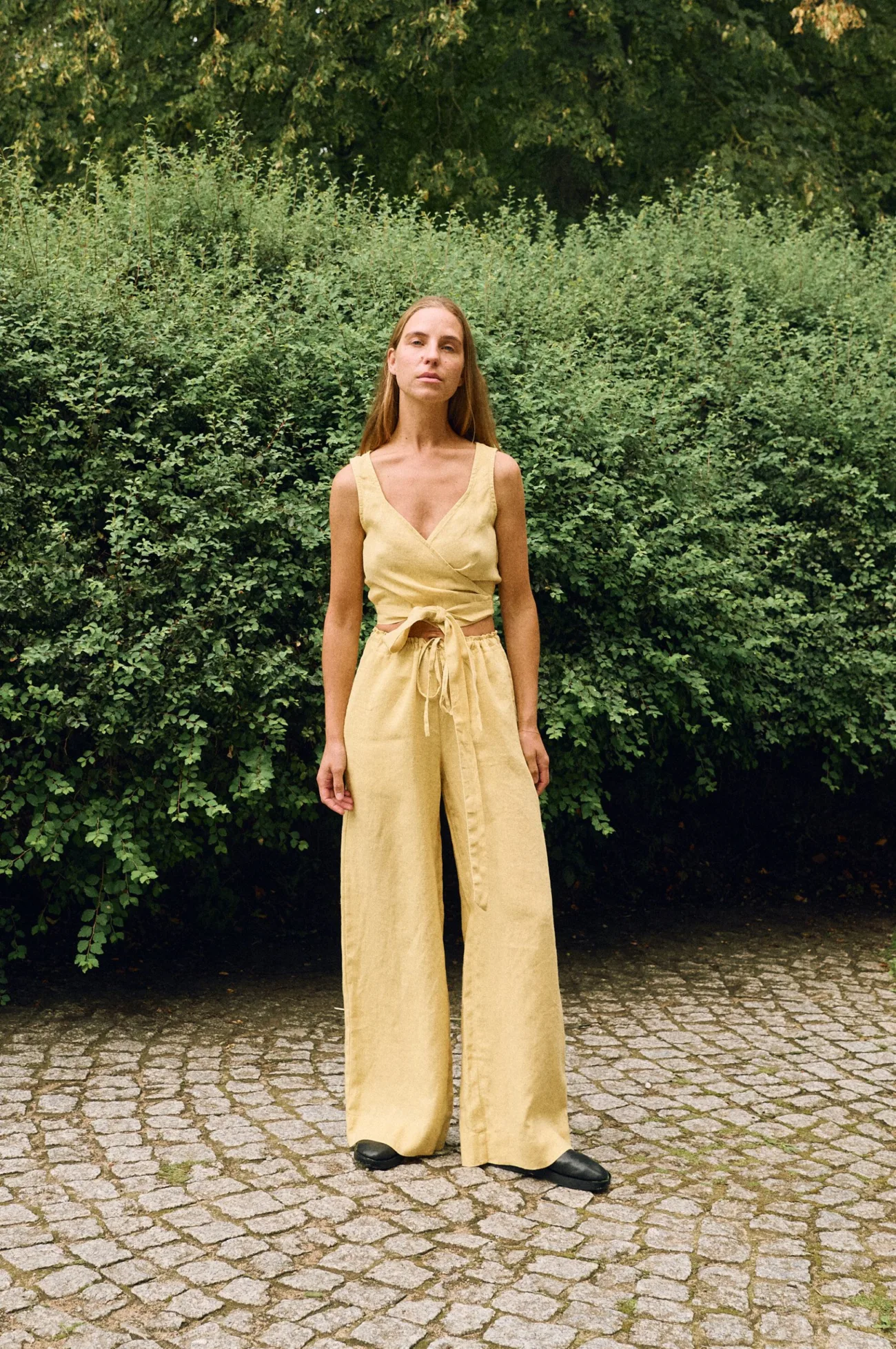 Butter linen two-piece set featuring a wrap crop top and wide-leg trousers, breathable women’s linen outfit