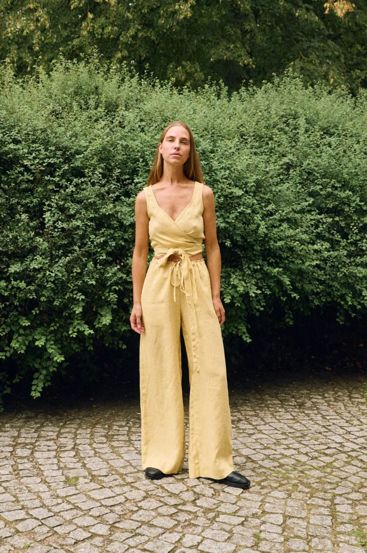 Butter linen two-piece set featuring a wrap crop top and wide-leg trousers, breathable women’s linen outfit