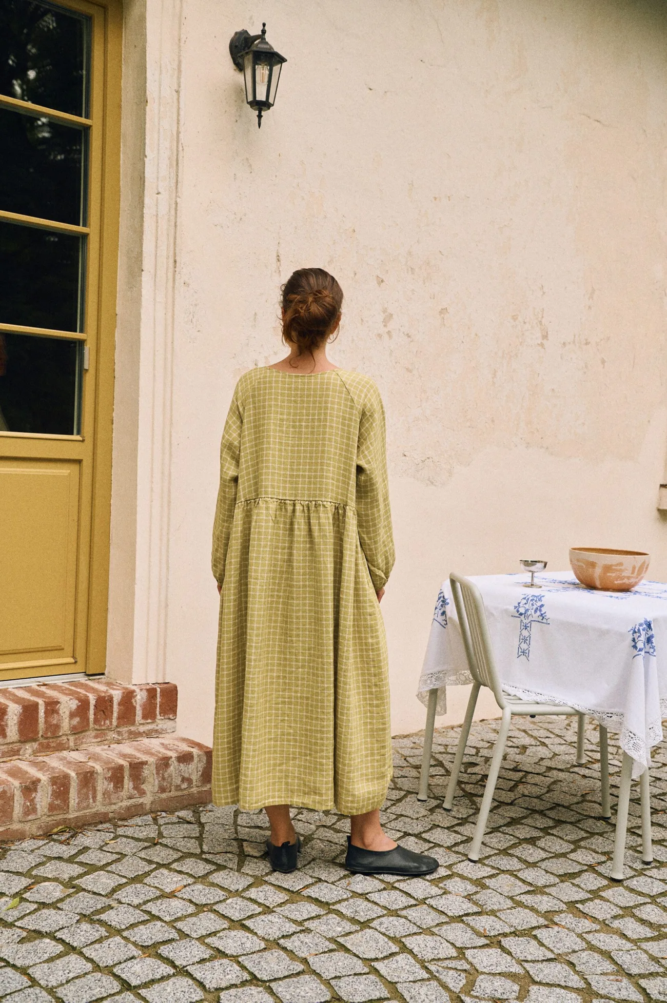 Back view of pickle green checks linen dress with relaxed oversized fit