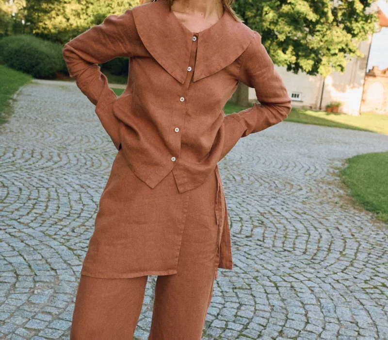 Front view of mocha mousse linen blouse with statement collar and relaxed fit, styled with matching linen pants with an overskirt