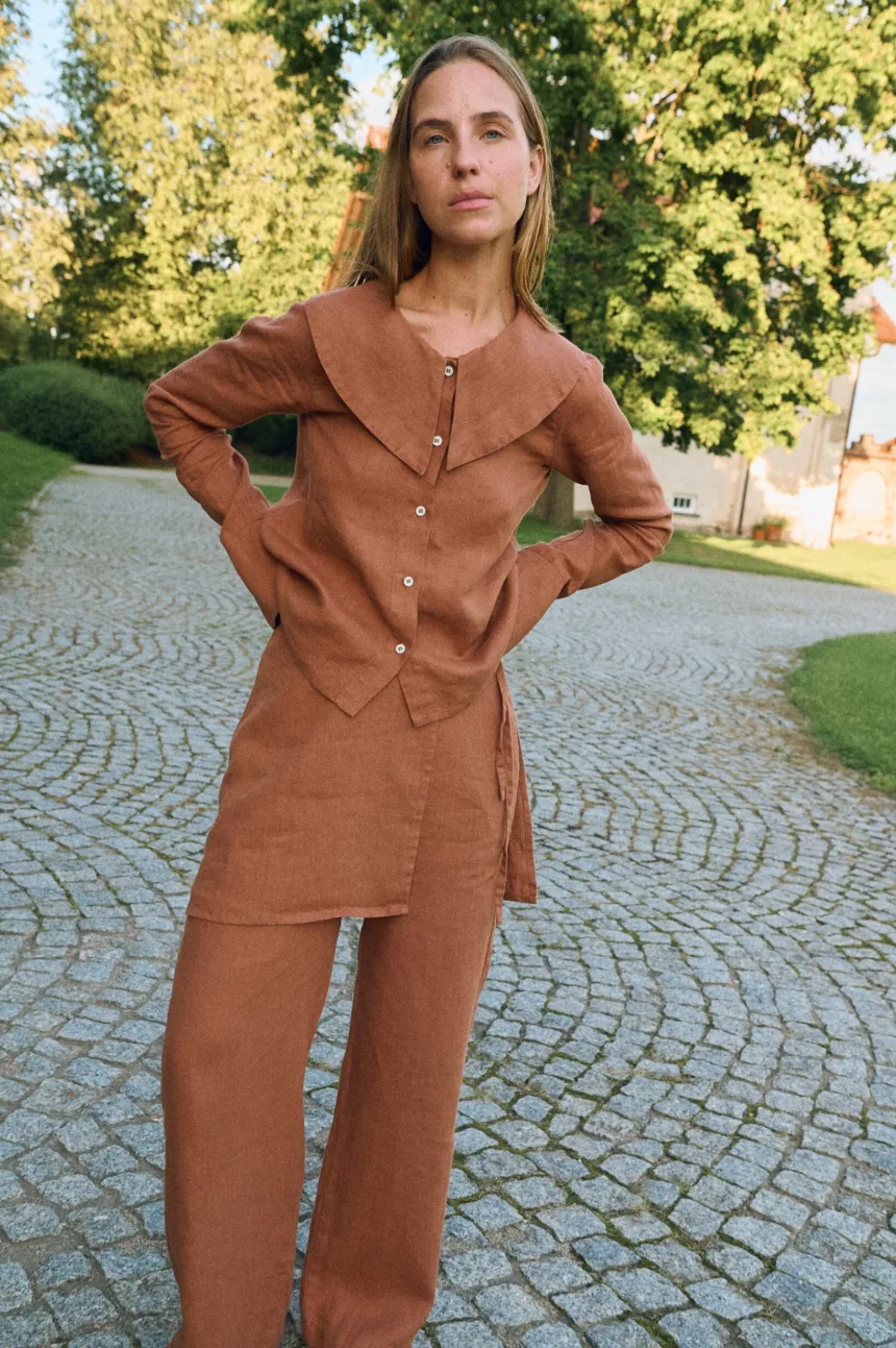 Front view of mocha mousse linen blouse with statement collar and relaxed fit, styled with matching linen pants with an overskirt