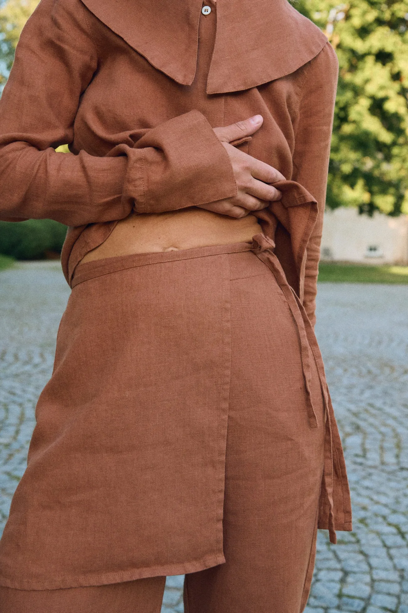 Close-up of mocha mousse linen wrap overskirt with adjustable side ties