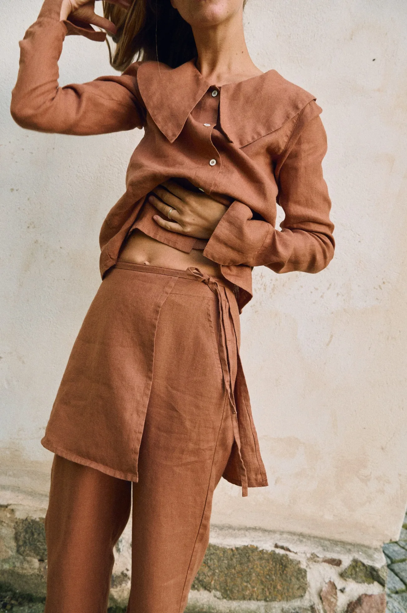 Detail of mocha mousse linen blouse collar and natural shell button fastening